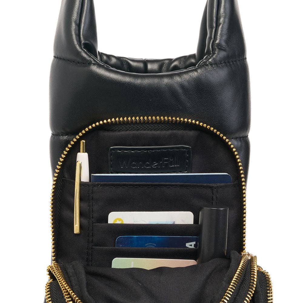 A Vegan Leather HydroBag® with a soft, padded strap for comfortable hands-free wear. It features a gold zipper, revealing a black fabric-lined interior with multiple credit cards, a pen, and a booklet. Inside is a small leather label that reads "WonderFull.
