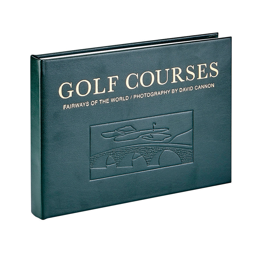 Green leather-bound edition titled "Golf Courses - Fairways of the World" featuring renowned golf course photography by David Cannon. The cover includes an embossed illustration of a famous golf course with a bridge.