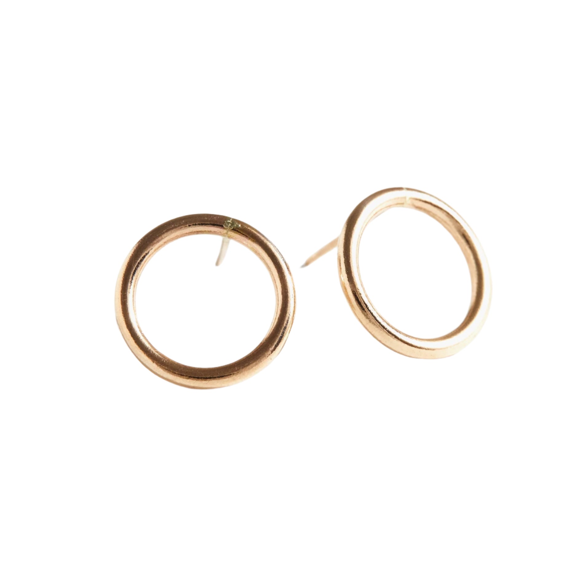 Presenting the Celine Stud Earrings, a pair of minimalist gold-filled hoops, each showcasing a small circular loop design. Perfect for everyday wear, they lie flat on a white surface with gentle shadows beneath, accentuating their simple elegance and polished finish.