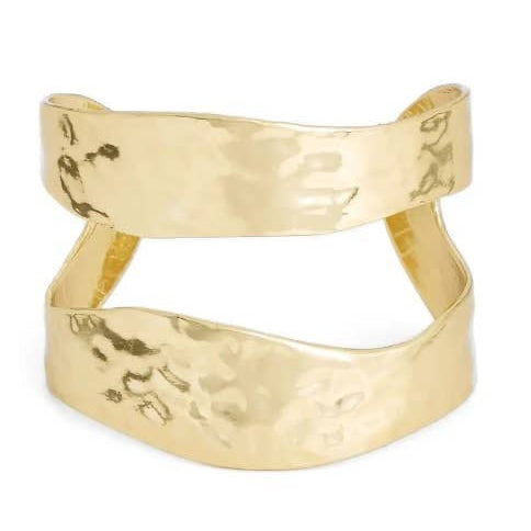Discover the Split Cuff, a best-selling textured gold bracelet with overlapping bands and a hammered finish. Its uneven, slightly curved design exudes an organic artistry. This bold statement piece reflects light beautifully, highlighting its elegant and innovative style.