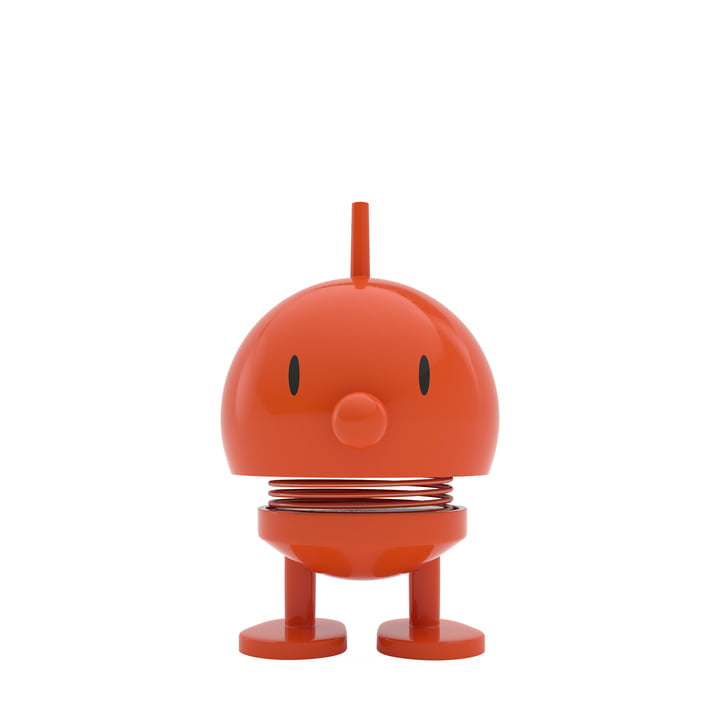 The Hoptimist Bumble figurine, a piece of Danish design history, is playful and simplistic with its red, round shape. It includes a small antenna on top, round eyes, a beak-like nose, and has a spring coil neck for that characteristic bobble-head look. Supported by two flat feet against the white background, it's an ideal choice for home decor.