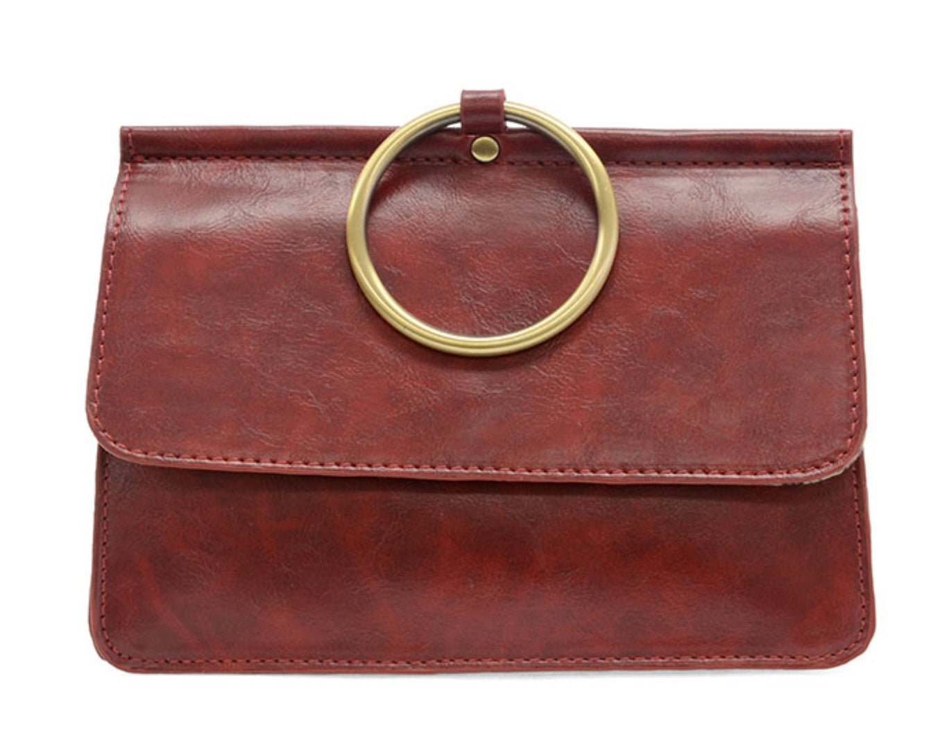 The Aria Ring Bag - Fall/Winter features a brown leather design with a large gold circular handle that resembles a bracelet bag, attached elegantly to the flap. Its textured finish and visible stitching enhance its minimalist elegance, making it an ideal accessory for both casual and formal occasions, effortlessly blending style with versatility.
