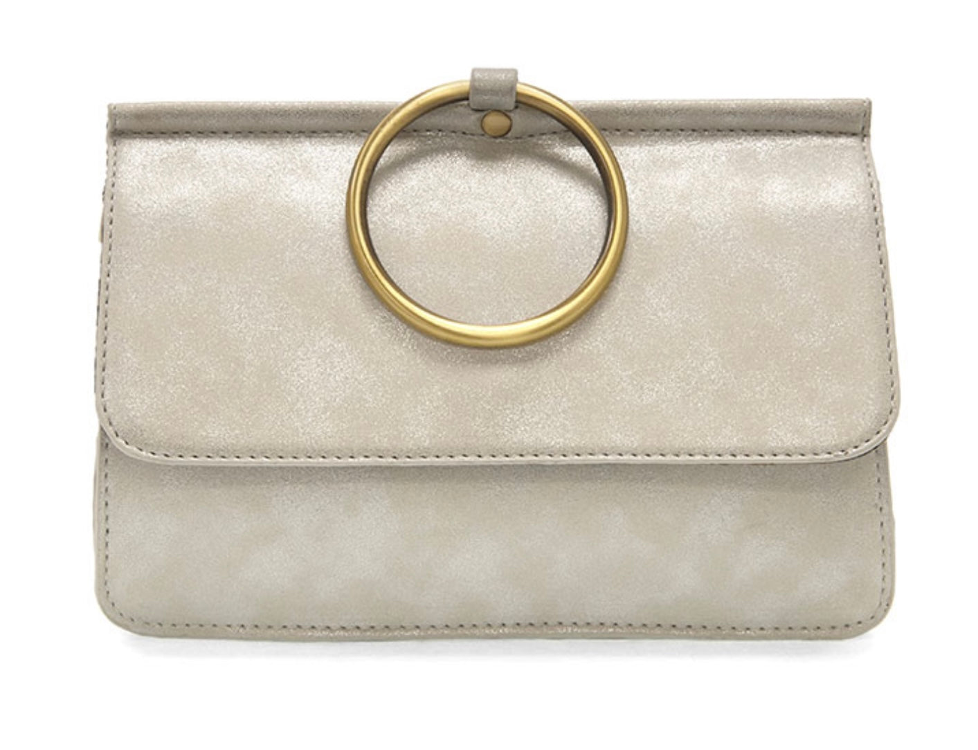 Introducing the Aria Ring Bag - Fall/Winter edition: a chic, pale beige clutch designed with vegan leather that boasts a smooth, shiny finish. This accessory is distinguished by a striking gold circular handle affixed to the top flap, evoking the charm of a bracelet bag. Its sleek rectangular silhouette is complemented by meticulously stitched edges, offering a contemporary and elegant style.