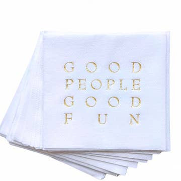 A set of Cloth-Like Cocktail Napkins, designed for year-round entertaining, features a foil embossed message "GOOD PEOPLE GOOD FUN" in capital letters. These paper napkins are neatly stacked, highlighting their elegant and festive appearance.