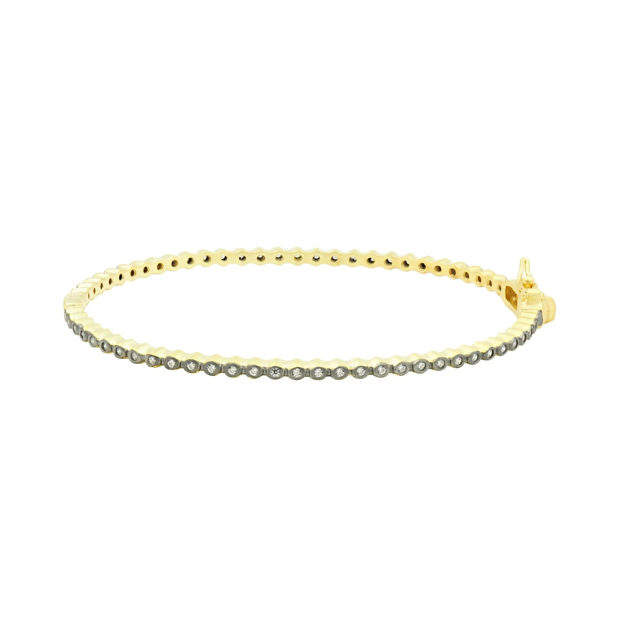 The Signature Bezel Pave Hinge Bangle is designed in 14K gold, showcasing a scalloped pattern adorned with shimmering cubic zirconia stones along its edge. Featuring a secure clasp, this bangle adds elegance and sparkle to any wrist, reflecting a sophisticated and luxurious style.