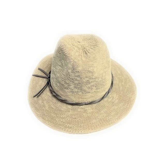 The Fedora Hat is a beige straw hat with a wide brim and SPF 50+ protection, adorned with a black ribbon around the crown that forms a small bow on the side. It's pictured against a white background, highlighting its woven texture and casual elegance.