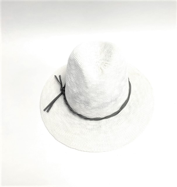A Fedora Hat with a wide brim rests against a white background, showcasing a thin black band tied in a knot for contrast. Its woven texture gives it a casual, summery look while providing SPF 50+ protection.