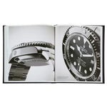 An open copy of *The Book of Rolex* reveals black-and-white images of a luxurious Rolex watch. On the left page, there's a side view showcasing the metal band and bezel, while the right page presents a close-up of the watch face with visible markers, hands, and intricate details, highlighting Rolex's design excellence and watchmaking expertise.