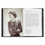 An open "Little Book of Chanel" reveals two captivating pages. On the left, a sepia-toned photograph captures a woman with short hair adorned in multiple pearl necklaces and a dark blouse echoing the style of a Chanel cardigan jacket, standing confidently with crossed arms. To the right, serif font text offers insights about this striking image.
