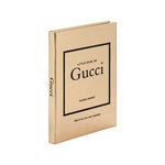 A beige hardcover book titled "Little Book of Gucci" is depicted, capturing the essence of Italian fashion. The minimalist design features black text and a border on the cover, with "Gucci" elegantly displayed along the spine. The book stands upright, slightly angled to the left.