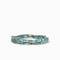 The Semi Precious Stone Stretch Bracelet showcases small, faceted, round beads in turquoise, brown, and beige tones. Its double-wrap design creates a layered appearance against a plain white background.