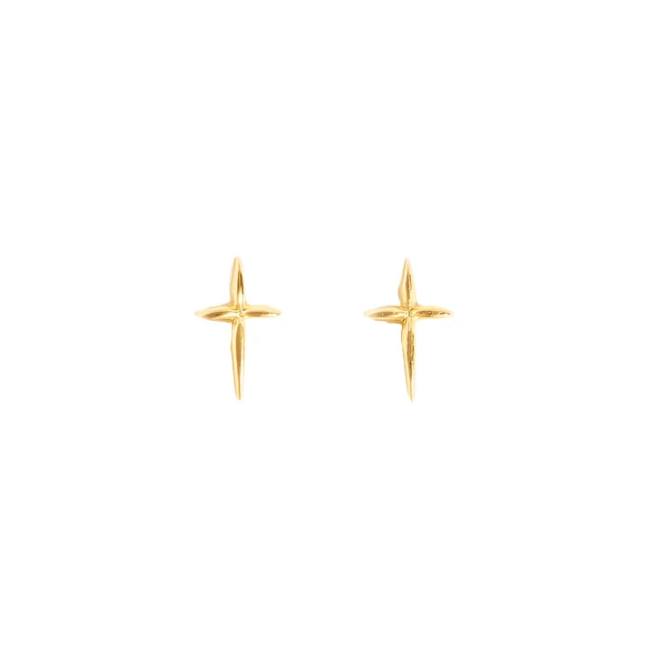 A pair of Droplet Cross Studs, minimalist vermeil stud earrings shaped as small, angular crosses on a plain off-white background. Handmade in Nashville, they feature a polished finish that exudes a subtle shine. The studs are symmetrically positioned to showcase their intricate detailing.