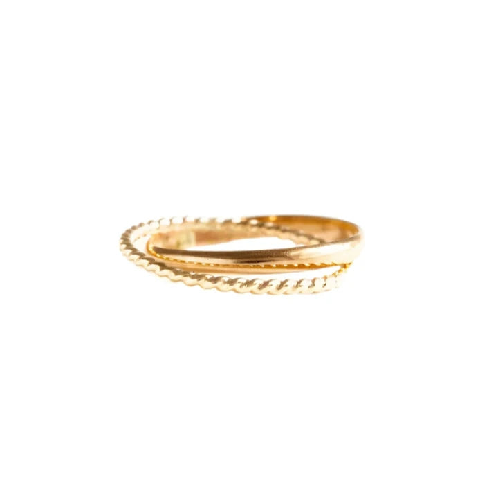 Two exquisite Virgil Rings are intertwined against a plain white background. One ring, featuring a simple gold-fill band, beautifully complements the other with its twisted rope design. Their arrangement casts a soft shadow below, enhancing the minimalist elegance of this handmade jewelry piece.