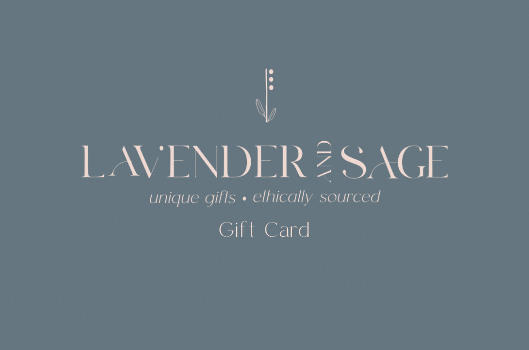 A minimalist design on this gift card features a muted blue background, with the words "Lavender and Sage Boutique" elegantly displayed in white font. A small plant graphic complements the text, which also includes "unique gifts • ethically sourced" and "Gift Card," all in matching white font.