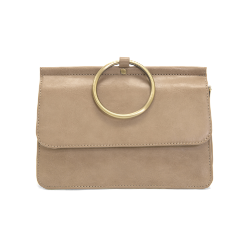 Introducing the Aria Ring Bag - Fall/Winter edition, a beige vegan leather clutch designed with a sleek flap and accented by a prominent gold ring handle at the top center. This clutch boasts a smooth texture with subtle edge stitching, exuding an elegant minimalist style. For ultimate versatility and sophistication, it features a detachable shoulder strap to enhance its functionality as a bracelet bag.