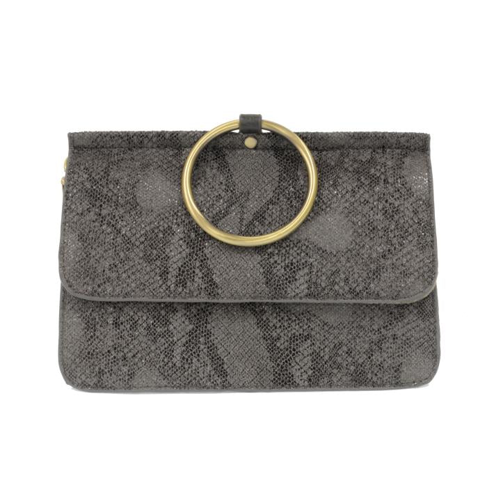 Introducing the Aria Ring Bag - Fall/Winter, a fashionable gray clutch made from luxurious vegan leather, showcasing a textured abstract pattern. The elegant design is highlighted by a prominent gold ring on the front flap, perfect for adding an air of sophistication. This sleek rectangular bag easily converts into a bracelet bag for versatile style options.