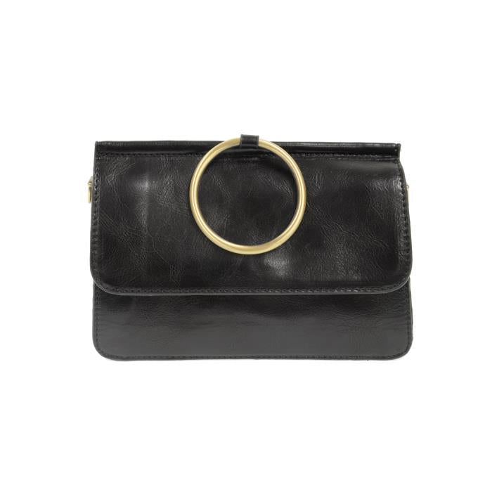 The Aria Ring Bag - Fall/Winter is a black vegan leather clutch with a smooth texture and a prominent large gold ring handle on the flap. It features a sleek and minimalist design, complete with a front flap closure, while the gold ring enhances its sophisticated bracelet bag look.