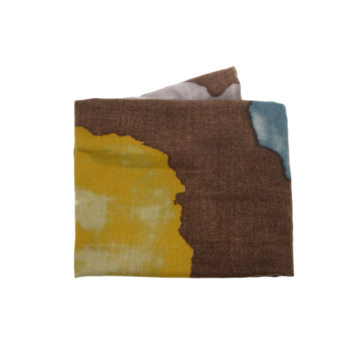 A Midweight Patterned Scarf featuring an abstract design with sections of brown, yellow, white, and blue. The pattern resembles cheetah-like shapes with soft, blended edges. The scarf is neatly folded to highlight its textured fabric and vibrant colors.