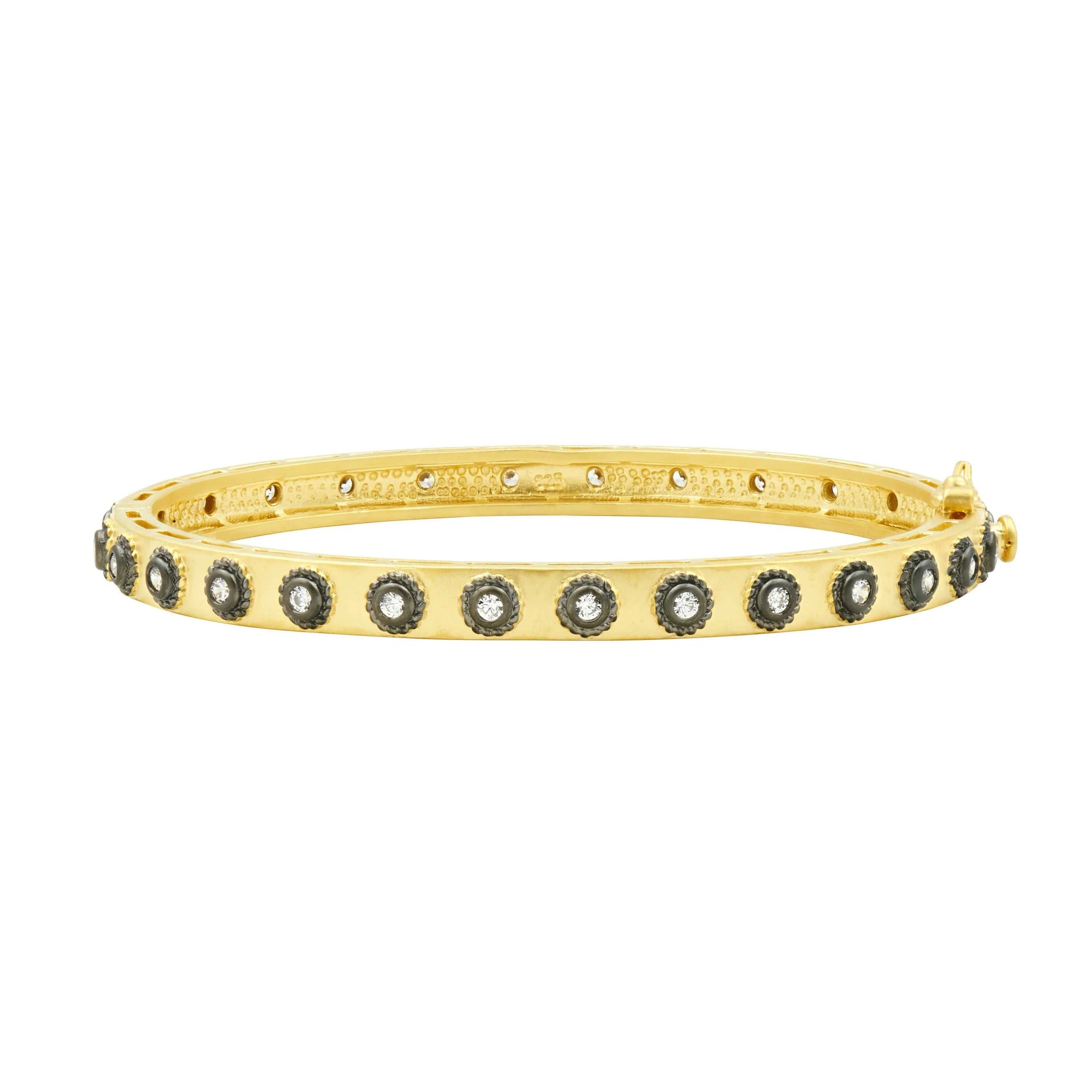 The Studded Eternity Hinge Bangle features dark gemstones arranged in a row along its polished surface. Created with a clasp for secure fastening, it is ideal for stacking, bringing elegance and flair to any outfit.