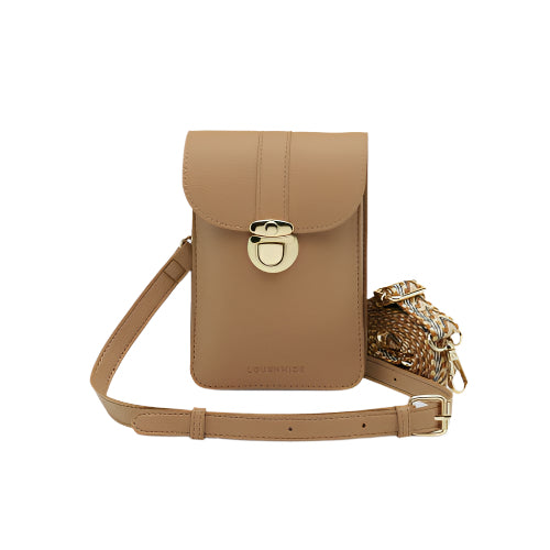 The Fontaine Phone Bag, crafted in tan leather, showcases a flap cover with a gold clasp and features adjustable straps highlighted by gold chain accents and braided detailing. A subtle shadow behind the bag against a light gray background adds to its elegant appeal.