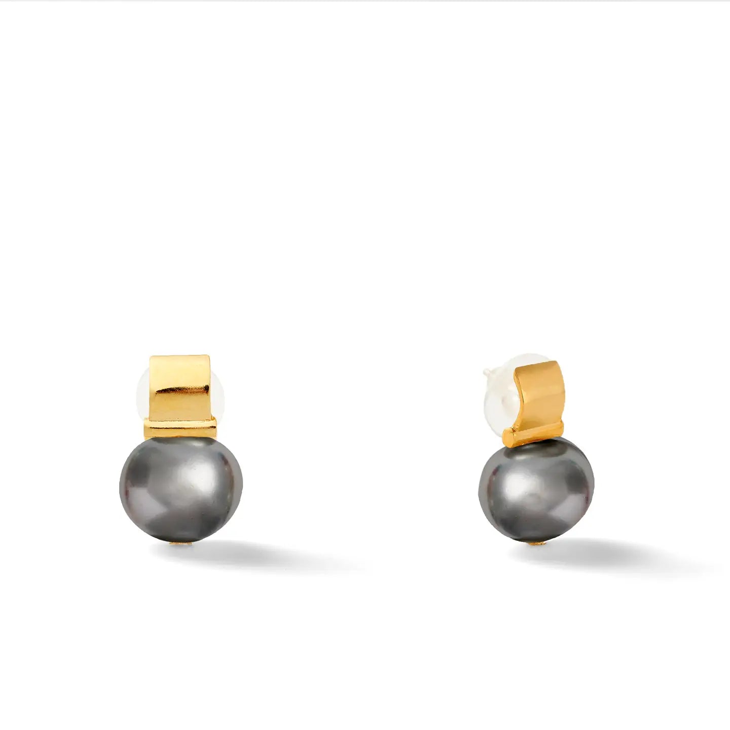 Introducing the Smooth + Classic Pebble Pearl Post Earrings: These exquisite earrings feature a gold rectangular clip made from 14 karat gold, elegantly highlighting a creamy white pearl above and a larger dark gray pearl below. Designed with hypoallergenic backing, they are ideal for those with sensitive ears.