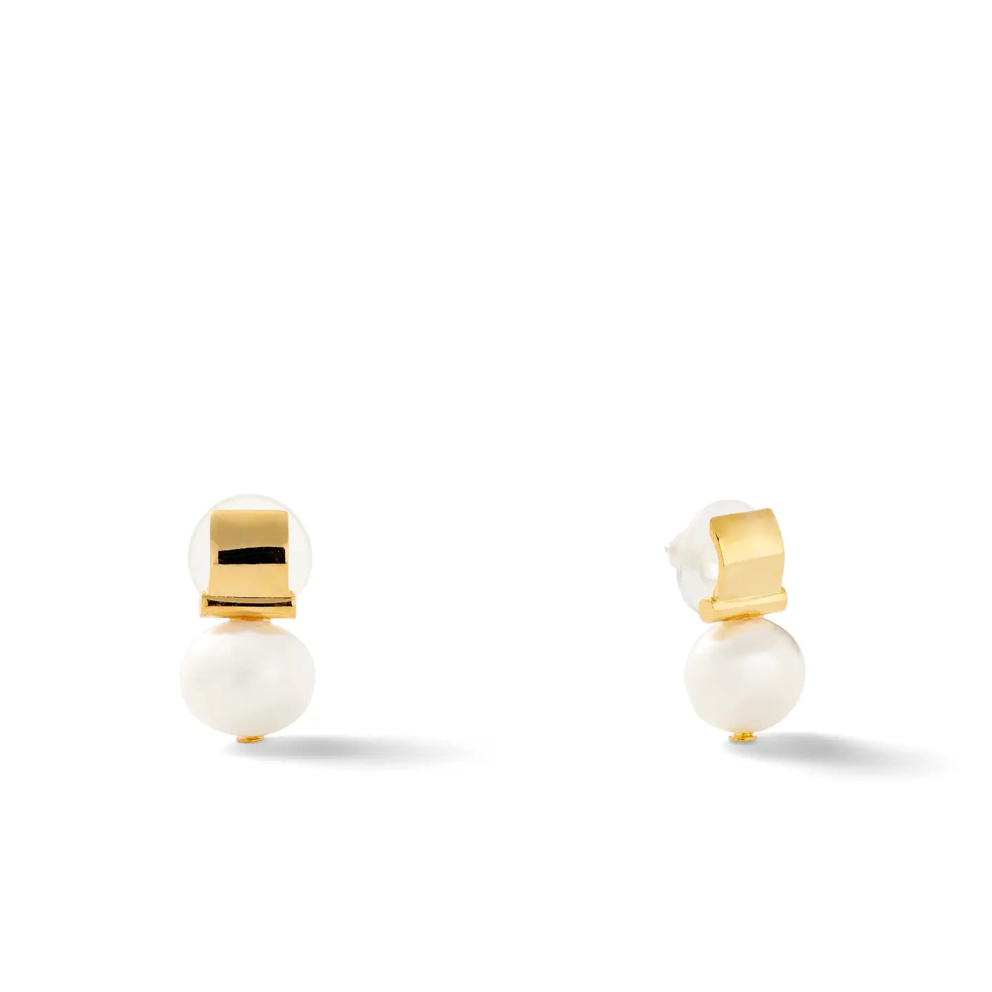 Smooth + Classic Pebble Pearl Post Earrings on a white background. These earrings feature a glossy pearl situated below a sleek 14 karat gold square accent, designed in a minimalist and elegant style. They include hypoallergenic backing for added comfort, with visible shadows beneath them.