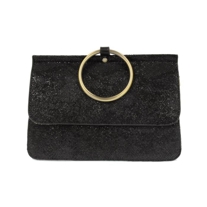 Introducing the Aria Ring Bag - Fall/Winter: a black clutch purse made from vegan leather, showcasing a shimmering texture and highlighted by a prominent gold circular handle on the flap. This bracelet bag maintains a sleek rectangular shape, with the handle acting as both an elegant design element and a practical carrying feature.