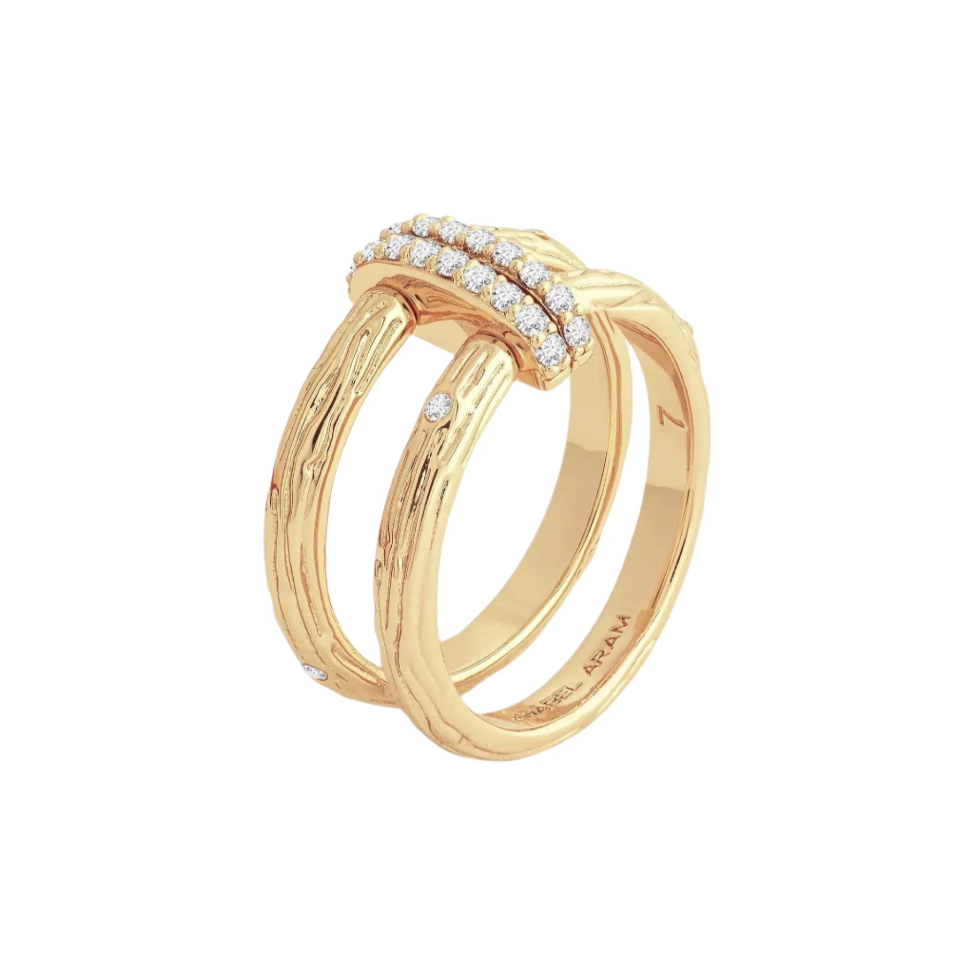 The Enchanted Forest Chain Double Ring features a dual-band design plated with 18K gold, highlighting a textured, bark-like pattern. The top is adorned with small, sparkling diamonds, and the inner band showcases intricate engravings. Set against an off-white backdrop, its elegance subtly radiates like a crystal in the light.