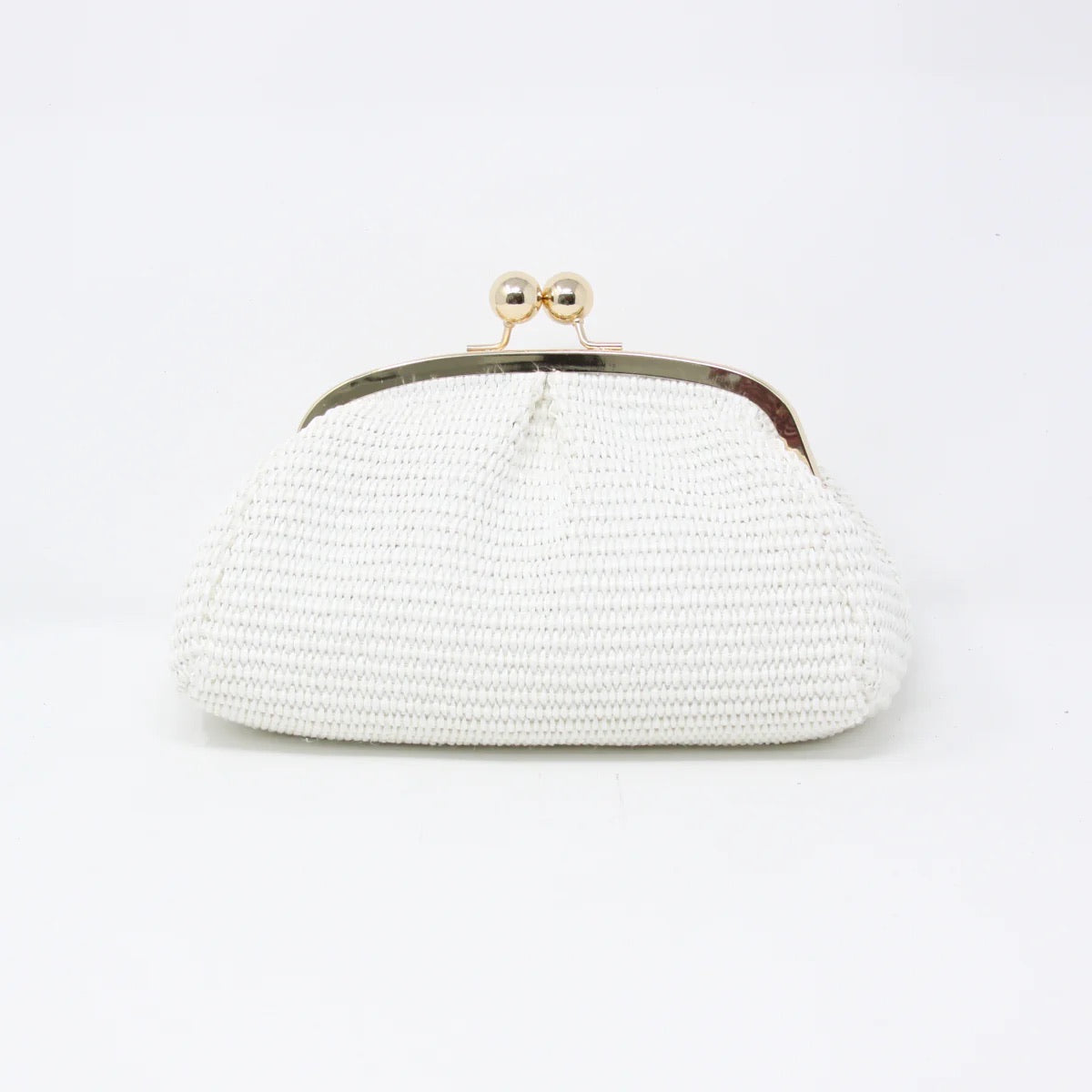 A white Raffia Bag, featuring a textured leather surface and a metallic clasp, rests against a plain background. The clasp's spherical knobs add vintage appeal to its elegant and minimalist design.
