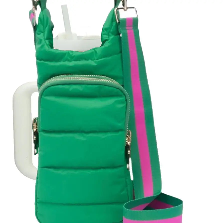 The HydroBag Handle is a green padded portable bag with a front zipper pocket and sturdy handle. It features a detachable wide green and pink striped strap with metal clasps. A white tumbler with a straw is partially visible inside, ideal for carrying your water bottle.