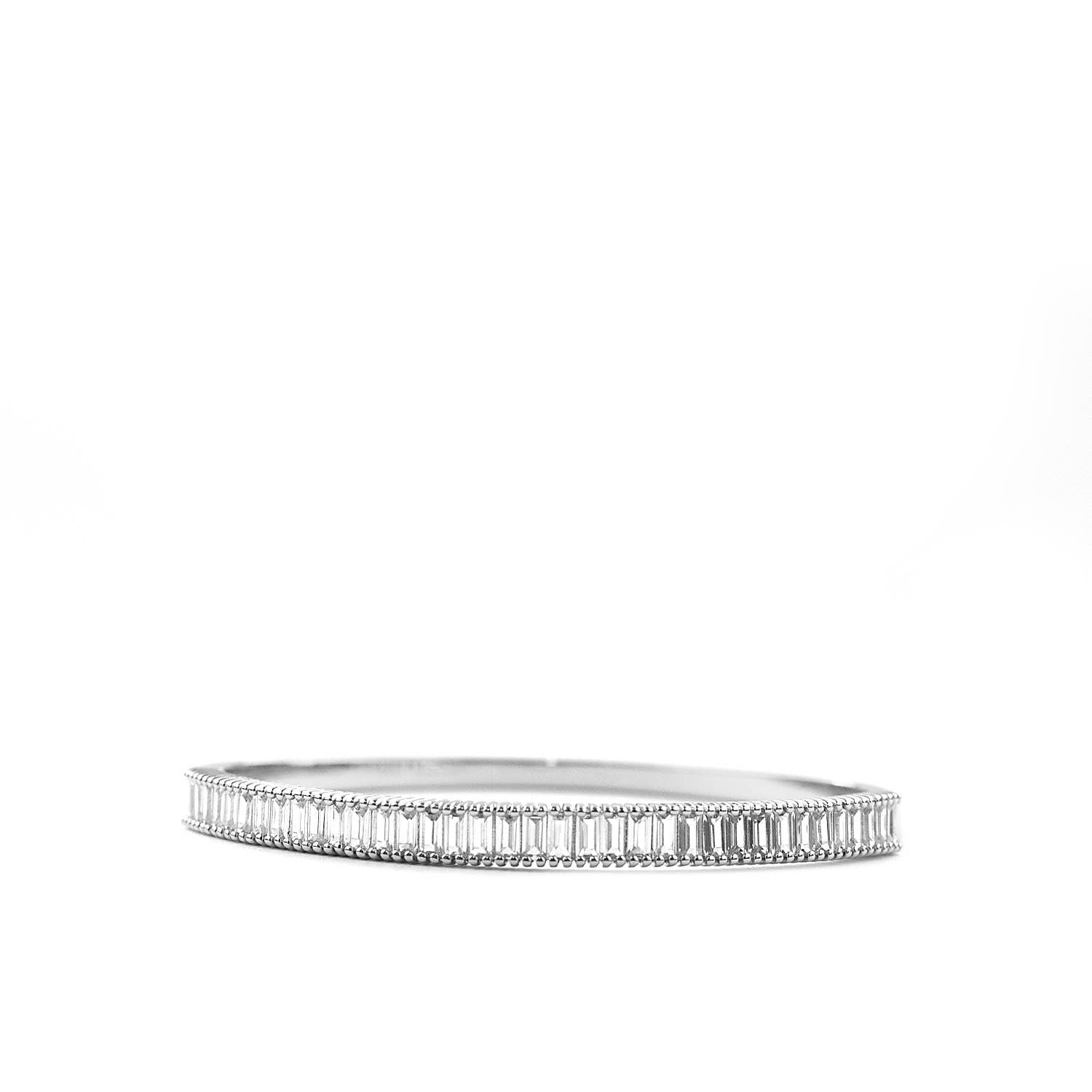 The Sterling Baguette CZ Hinged Bangle, with its rectangular art deco patterns and intricate beadwork, exudes elegance in a geometric design and polished silver finish against a plain white background.