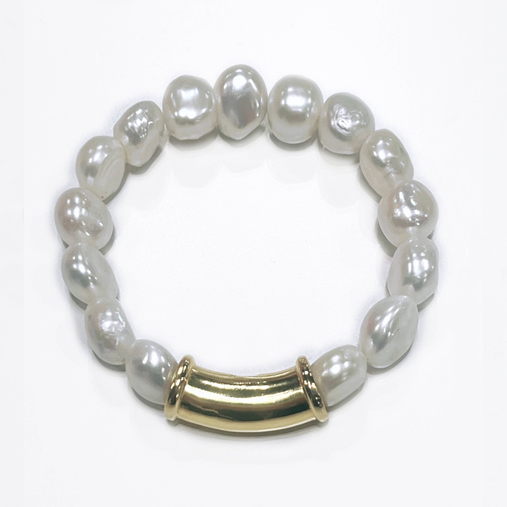 The Nugget Freshwater Pearl Bracelet is crafted with irregularly shaped freshwater pearls arranged on a circular band. A central 14-karat gold curved tube bead serves as an elegant focal point, and the lustrous sheen of the pearls, which vary slightly in size and shape, enhances the bracelet's unique appeal.
