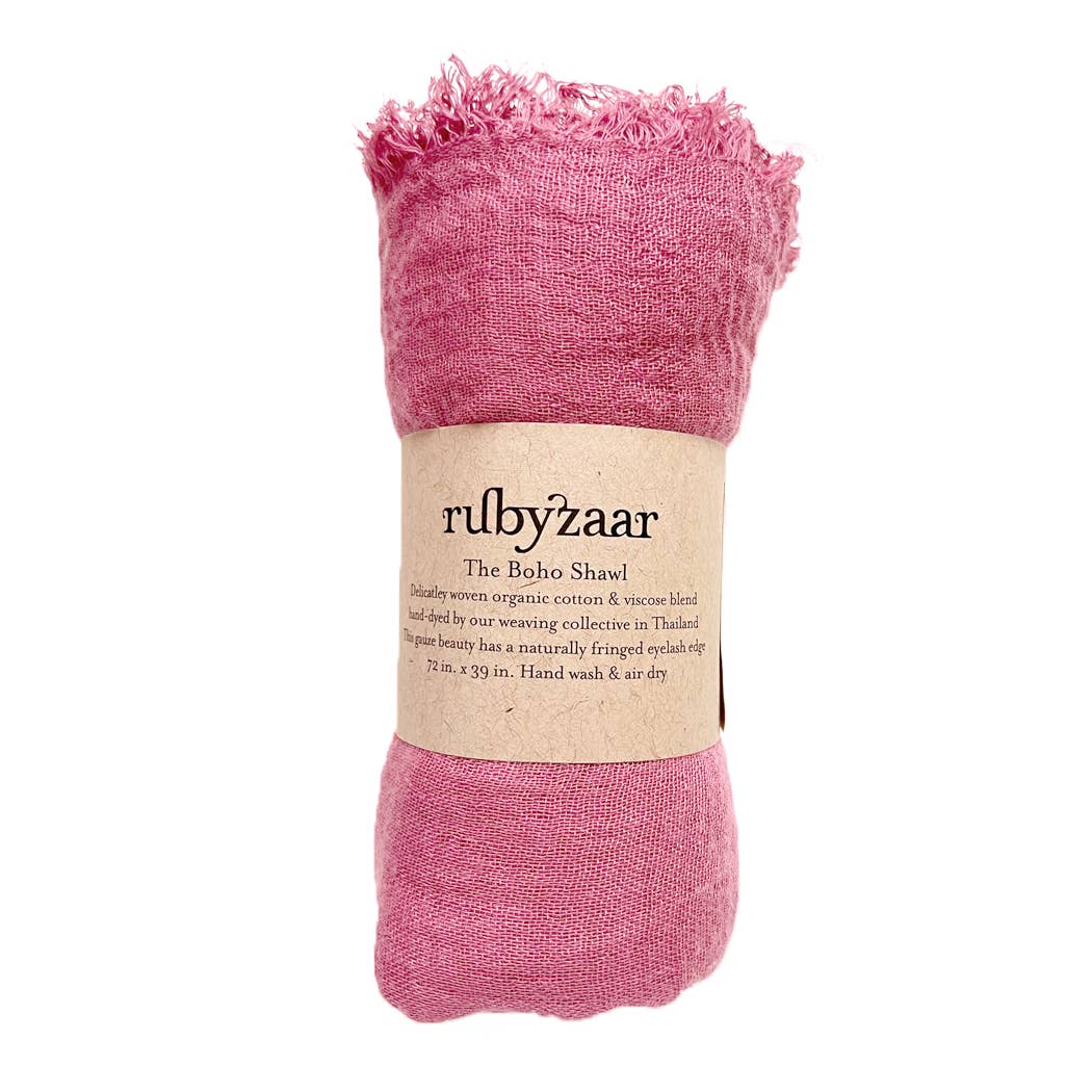 A pink cotton and viscose Boho Scarf, wrapped with a beige label that reads "rubyzaar, The Boho Shawl," exudes elegance. Handwoven in Thailand with fringed edges, this stunning bohemian-style accessory measures 72 inches by 39 inches.