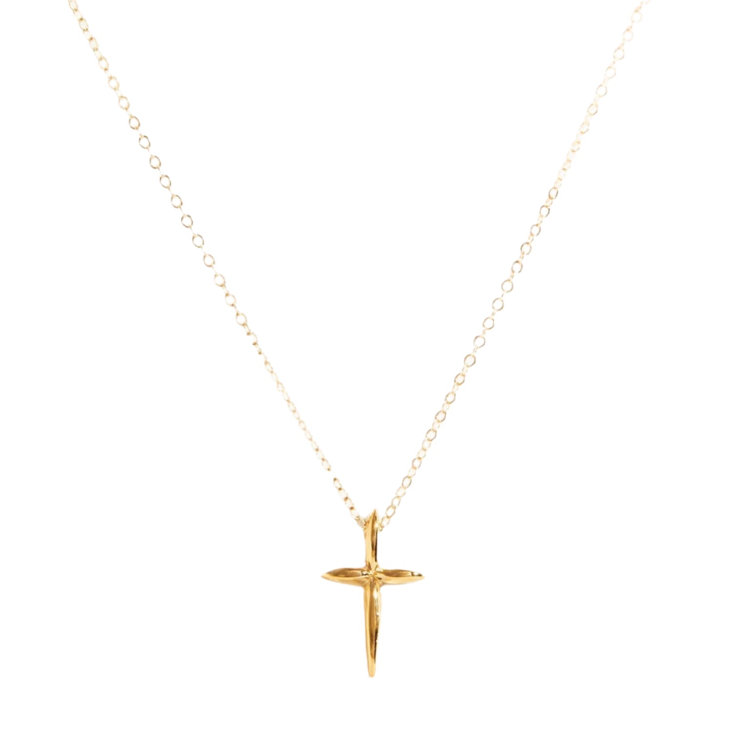 The Droplet Cross Necklace, a delicate vermeil piece handmade in Nashville, features a fine chain with a small, smooth cross pendant at its center. The simple and elegant design is highlighted against a plain white background to showcase the necklace's intricate details and shiny finish.
