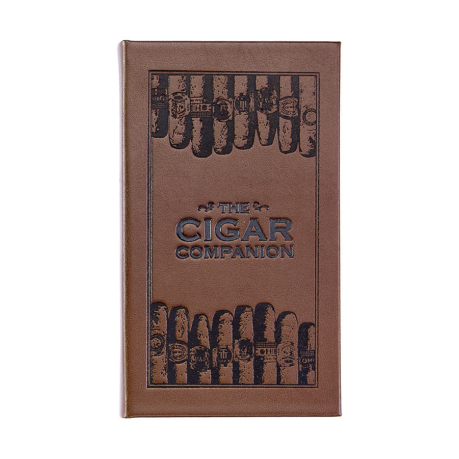 The Cigar Companion (Brown Bonded Leather) features a refined cover perfect for cigar enthusiasts, adorned with embossed images of handmade cigars showcasing different labels. The text appears in an elegant blue and is centered and embossed, enhancing its sophisticated look.