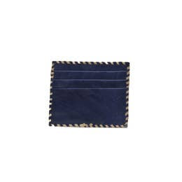 Introducing the Ivy Card Holder: a small, handmade accessory crafted from cowhide hairon leather. It features three horizontal slots and is adorned with a decorative brown and beige striped trim along the edges, adding a touch of design to its navy blue finish. Displayed against a plain white background, this textured cardholder is both stylish and functional.