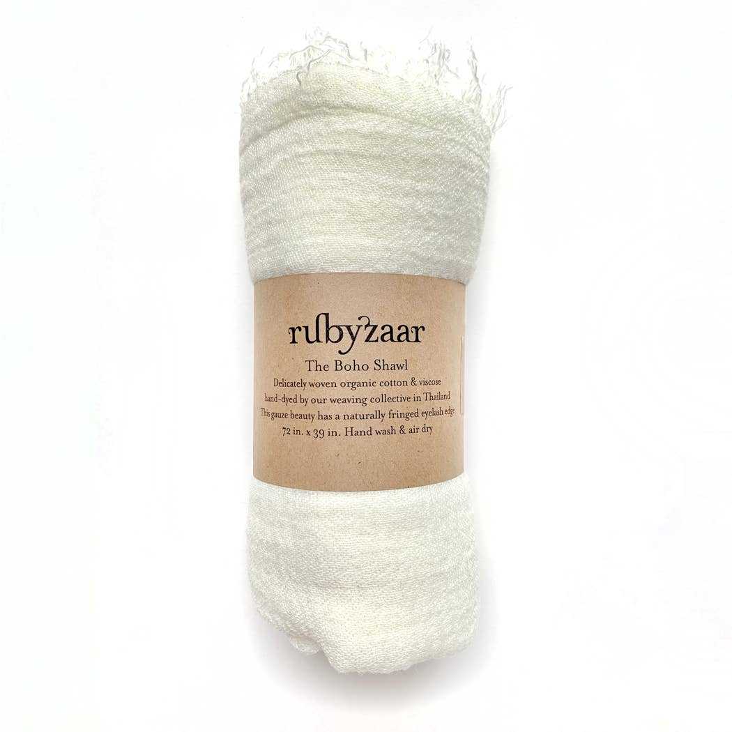 The "Boho Scarf" by rubyzaar is a beautiful bohemian-style accessory made from organic cotton and viscose. Hand-dyed in Thailand, it measures 72 x 39 inches. It has a soft and slightly fluffy texture, with care instructions that recommend hand washing and air drying.