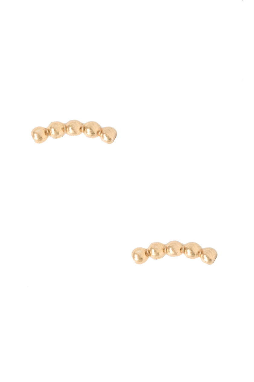 The Caesar Studs, a pair of small gold ear climbers, are showcased against a white backdrop. Made with 14k gold fill, each earring displays a sequence of five linked, smooth round beads that achieve a minimalist and refined appearance while reflecting ethical fashion values.