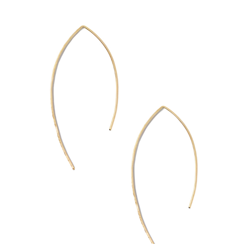 The Galaxy Earrings, crafted from minimalist 14k gold-fill, are showcased on a white background. Each piece boasts a gently curved, delicate arch that forms an elegant and simple teardrop shape. This slender design exudes understated sophistication and modern style, symbolizing women empowerment within ethical fashion.