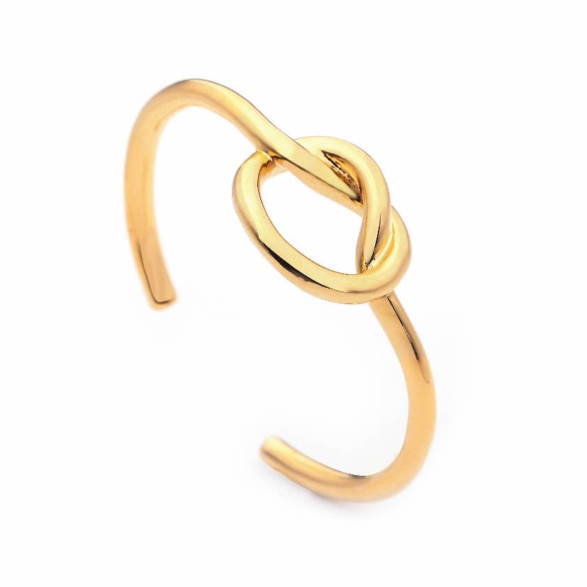 Introducing the Knot Cuff, a gold cuff bracelet showcasing a simple, elegant design with an open-ended band. The centerpiece features a sophisticated gold knot design, exuding a modern and stylish appeal. Its polished 18K gold finish enhances its luxurious appearance, making it suitable for both casual and formal occasions.