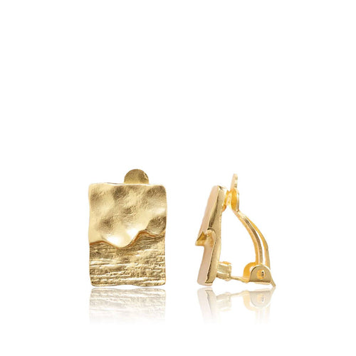 The Textured Elongated Clip-On Earrings feature a sleek rectangular shape with a dual texture design in 24 kt gold. One earring showcases a wavy texture, and from the side view, you can see the clip-on mechanism. These polished and shiny earrings exude an elegant and minimalist charm.