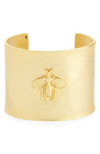 Load image into Gallery viewer, The Bee Design Hammered Cuff Bracelet is a wide gold bangle featuring a raised bee design at the center, with a smooth, hammered finish and an open back for adjustable fitting. The finely crafted bee detail adds an elegant touch to its minimalist design.
