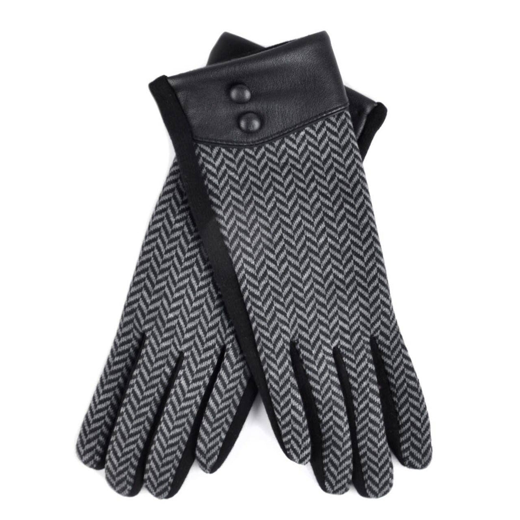 Introducing the Women's Chevron Touch Screen Winter Gloves, a sophisticated pair designed with a gray and black herringbone pattern. These elegant gloves feature black leather cuffs adorned with two buttons each, offering a sleek and stylish look. They are artfully displayed one over the other on a white background.