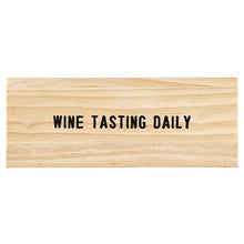 Load image into Gallery viewer, The Gold Wine Charms in Pine Box – Wine Tasting Daily, featuring bold black lettering on a natural wood grain, makes a perfect gift for any occasion.
