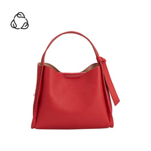 Load image into Gallery viewer, The Felicity Red Recycled Vegan Top Handle Bag is a chic red leather handbag with a minimalist design, featuring a single short strap and small tie detail. It has a textured finish and clean structure. The plain white background is accented by a small black abstract logo in the top left corner.
