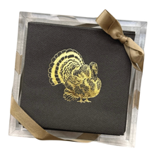 Load image into Gallery viewer, A stack of black disposable napkins featuring a shiny gold turkey design is elegantly arranged in an acrylic tray and tied with a gold ribbon bow at the top right corner—an ideal hostess gift from the &quot;Cocktail Napkin Acrylic Tray Set - Year Round Entertaining.
