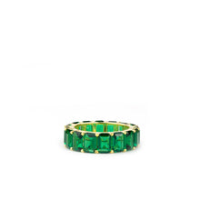 Load image into Gallery viewer, The Gold Plated Large Baguette Ring, featuring an arrangement of rectangle-cut green gemstones set into the band, is displayed against a simple white background. The stones are uniformly distributed around the ring, forming a sleek and unbroken design that embodies stylish elegance.
