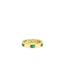 Load image into Gallery viewer, Introducing the Gold Plated Spaced Baguette Eternity Ring, featuring a series of five rectangular emerald green stones evenly spaced around the band. This statement piece is polished to a high finish and engraved with &quot;925K&quot; on the inside, indicating its metal purity. The flush baguette stones create a sleek, modern aesthetic ideal for making a bold impression.
