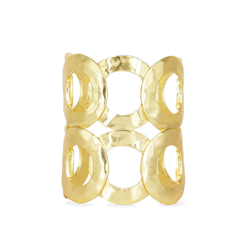 The Intertwined Rings Cuff Bracelet, part of the Fall Jewelry collection, is a true statement piece with its bold open-work design composed of four large interconnected circular loops. Its gold-plated surface is polished and reflective, featuring a slightly hammered texture that adds unique visual interest.