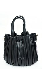 Load image into Gallery viewer, The Pleated Bucket Bag, crafted from black leather and adorned with a pleated design, is an ideal accessory for any occasion. It boasts two sturdy handles connected by metal rings and features drawstring details, along with a small tag on one handle. The bag is elegantly displayed against a plain white background.
